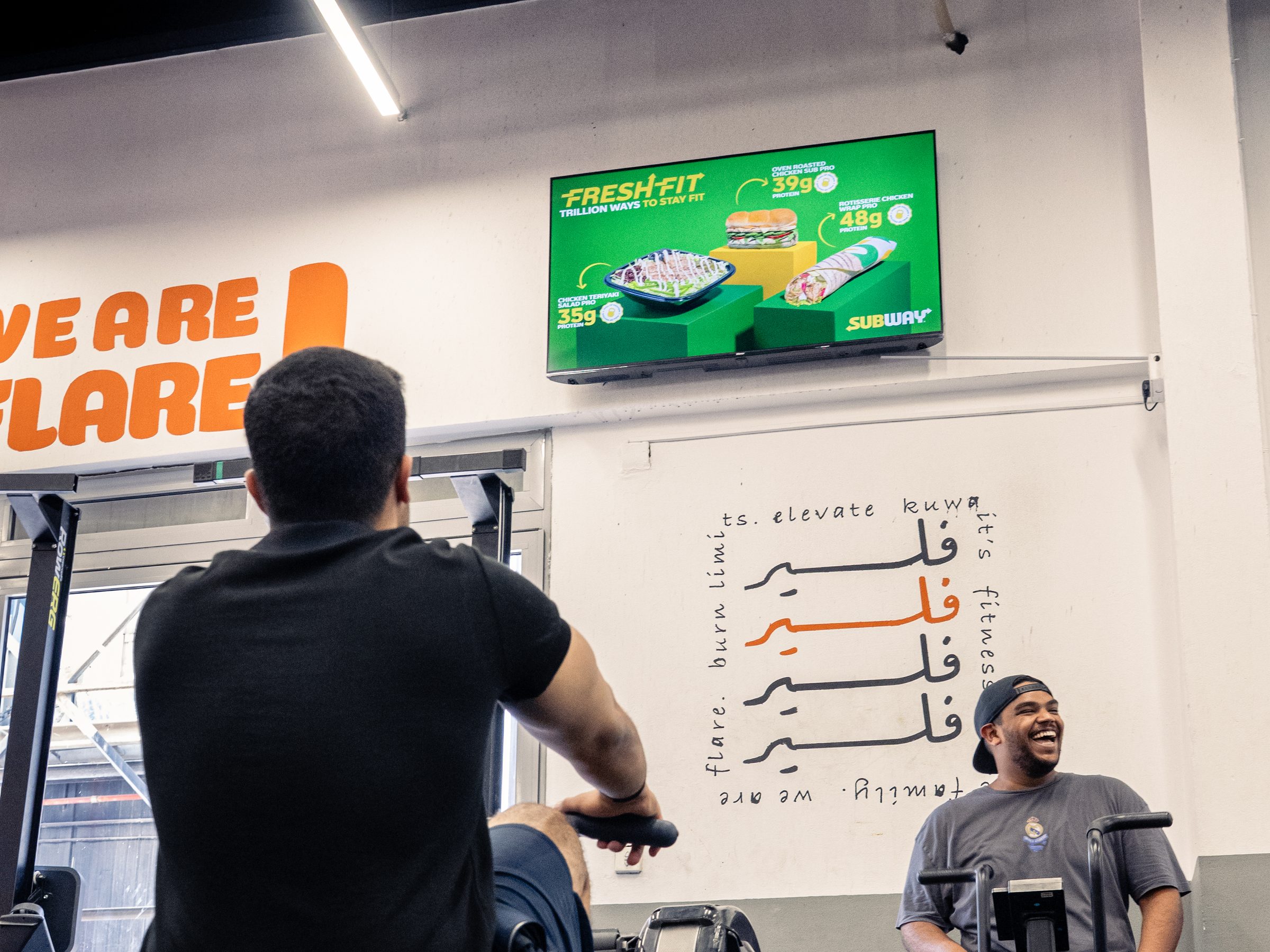 A Subway ad on an Ad Space screen above members training at Flare gym in Kuwait