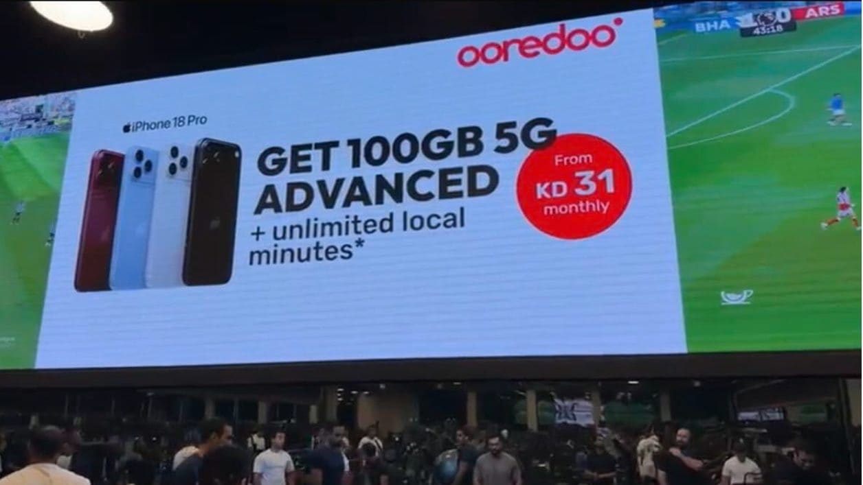 Ooredoo's entry offer for the new iPhone Pro across a giant screen above a men's gym floor